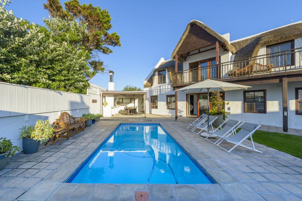 a swimming pool in the backyard of a house at Moana Bay in Kommetjie