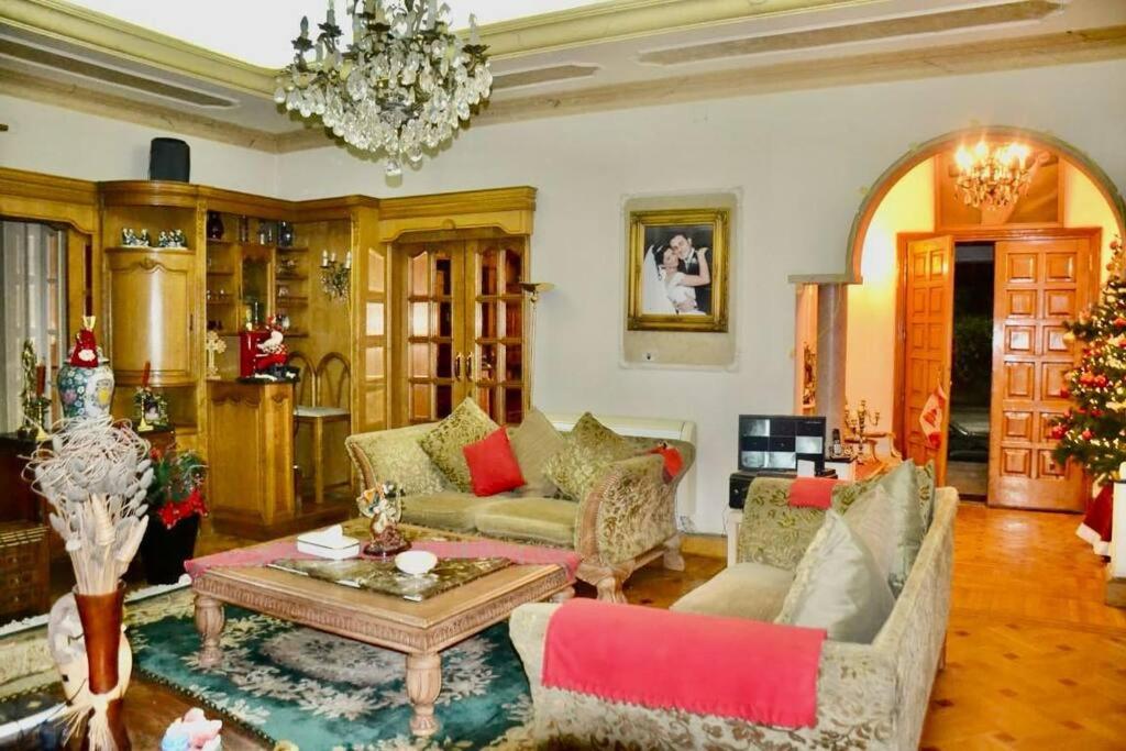 a living room with a couch and a table at Luxury Vacation Villa in Cairo