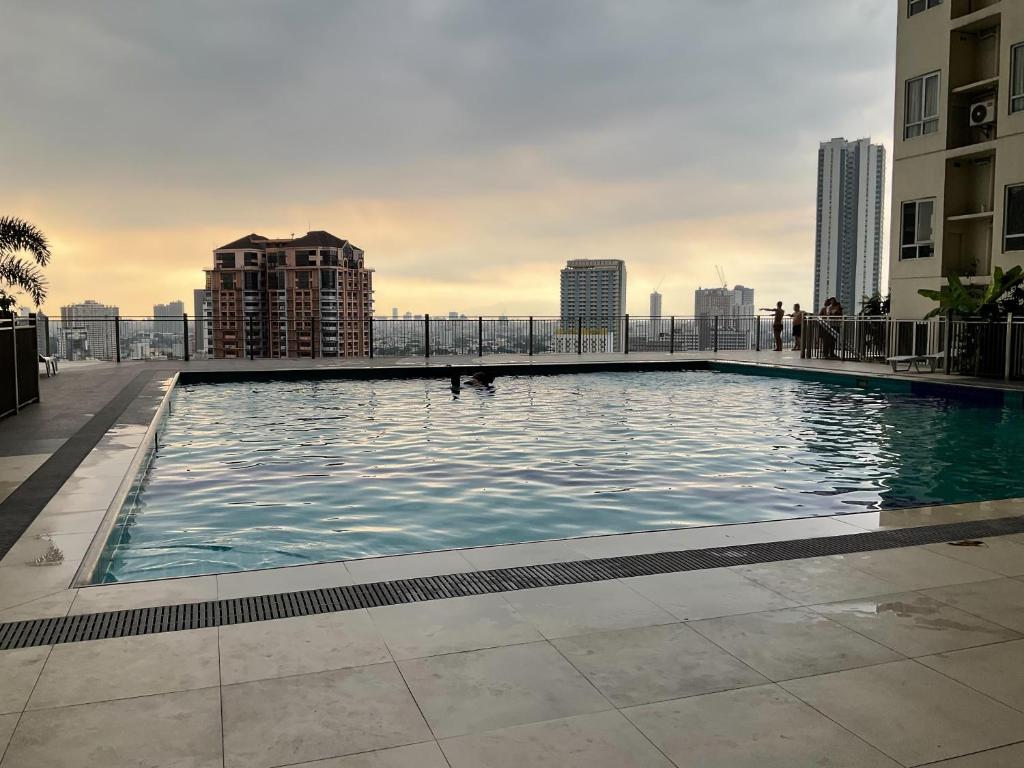 a large swimming pool on the roof of a building at JNL Victoria Sports Towers condo - GMA, Quezon city in Manila
