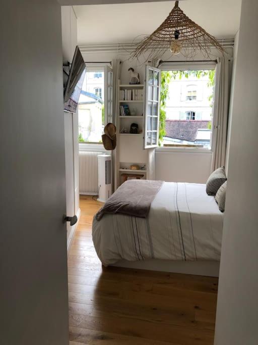 - une chambre avec un lit et une fenêtre dans l&#39;établissement Appartement cosy esprit loft, à Paris