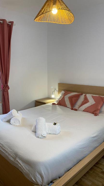 a bedroom with a bed with towels on it at Casa rural completa y con garaje in Vigo