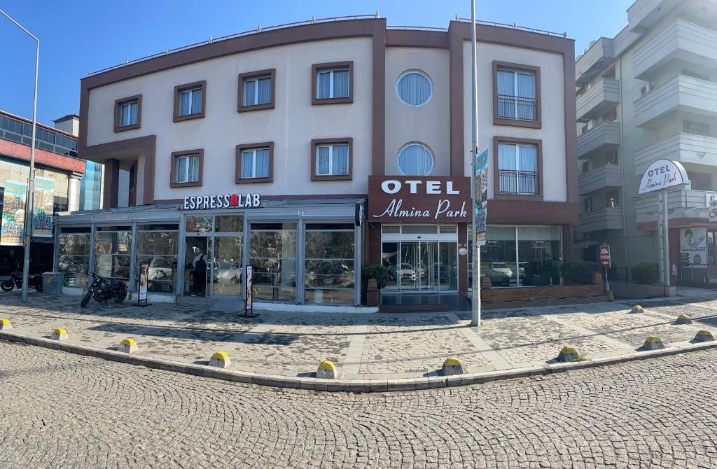 a building on a street in front of a store at Hotel Almina Park in Duzce