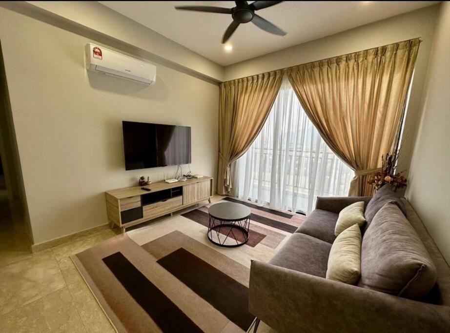 a living room with a couch and a flat screen tv at IPOH Tambun the cove your ultimate relaxing gateaway 111 in Ipoh