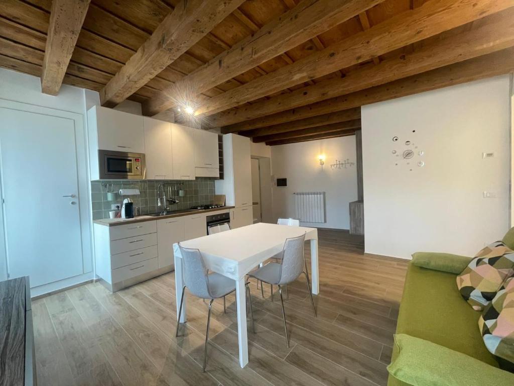 a kitchen with a white table and chairs in a room at CAIROLI14 in Brescia