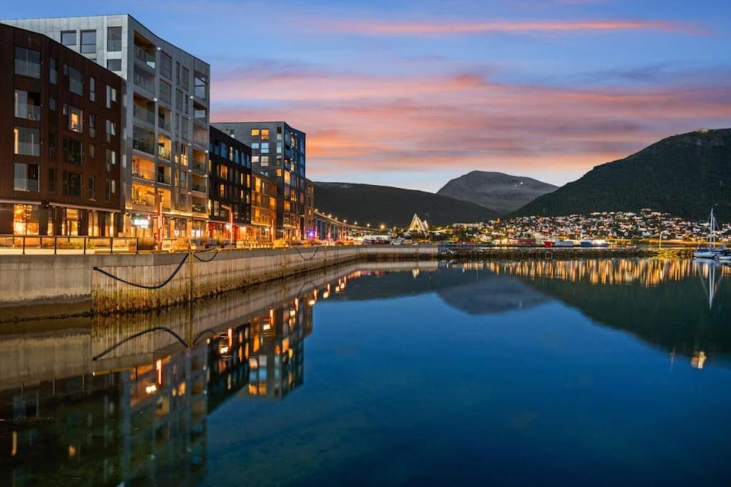 a city with buildings and a body of water at Ny leilighet i Tromsøs nye bydel in Tromsø