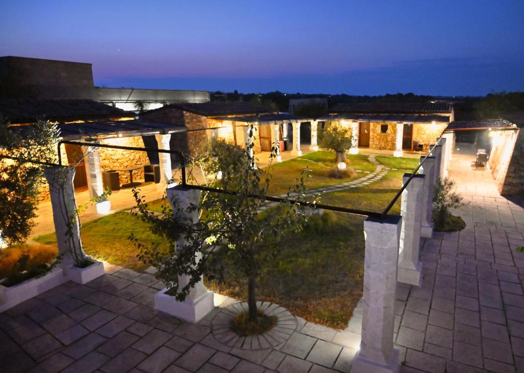 a view of a building with a courtyard at night at Tenuta Serre in Salve