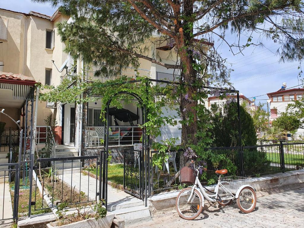 a bike parked in front of a fence at Bahçeli çift katlı villa sahile 300 metre in Kusadası