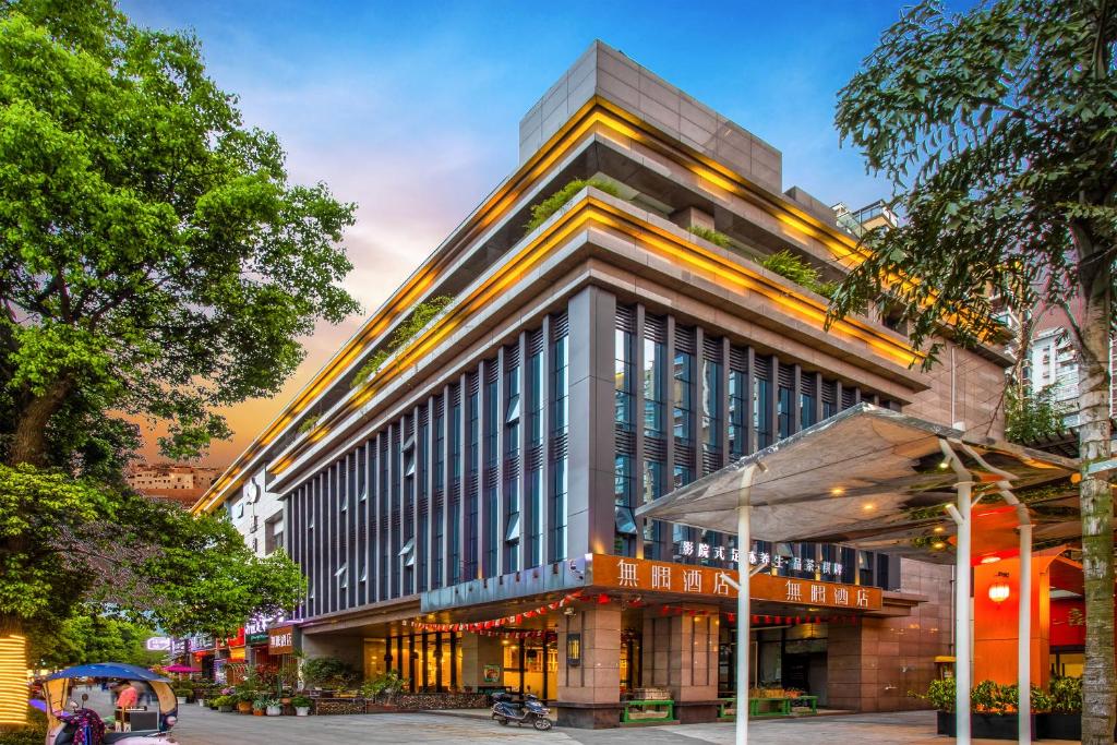 a large building on a city street at Wuyu Hotel Chongqing Jinyun Mountain Southwest University in Chongqing