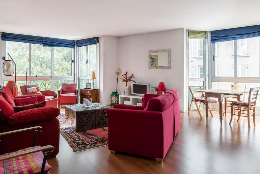salon z czerwonymi krzesłami i stołem w obiekcie Charmant 3P. Calme, spacieux et lumineux. 90 m2 w Paryżu