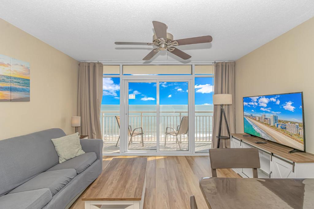 a living room with a couch and a ceiling fan at Atlantica 757 in Myrtle Beach