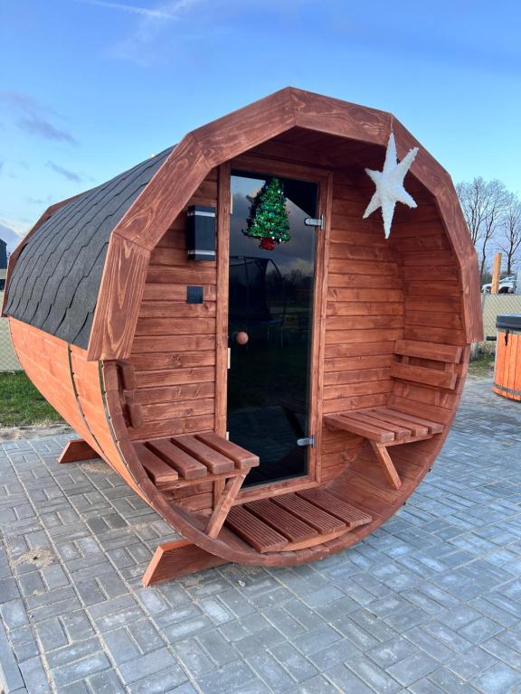 a small wooden boat with a christmas tree in it at Słoneczny Horyzont in Zastań