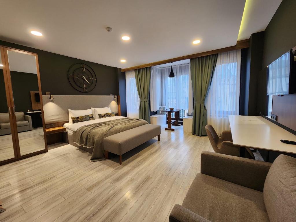 a bedroom with a bed and a couch and a tub at Taksim Landhouse in Istanbul