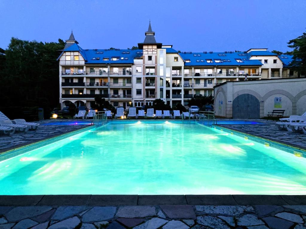 a large swimming pool in front of a building at Blue Mare BB in Łukęcin