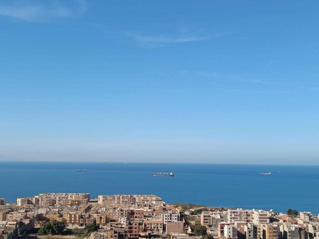 a view of a city with buildings and the ocean at Bel Horizon mosta in Mostaganem