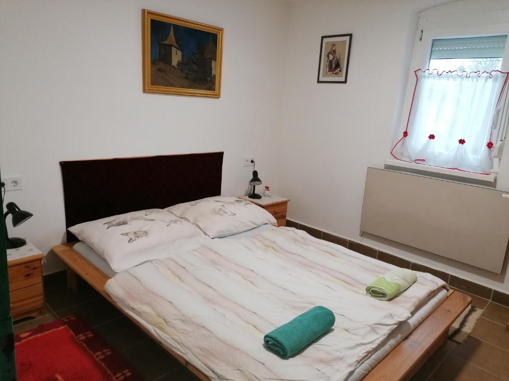 a bed with two pillows on it in a bedroom at Berkenyés Vendégház in Zalalövő