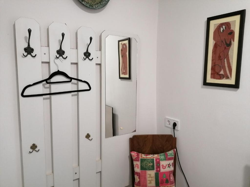 a room with white cabinets and a shelf with hooks at Berkenyés Vendégház in Zalalövő