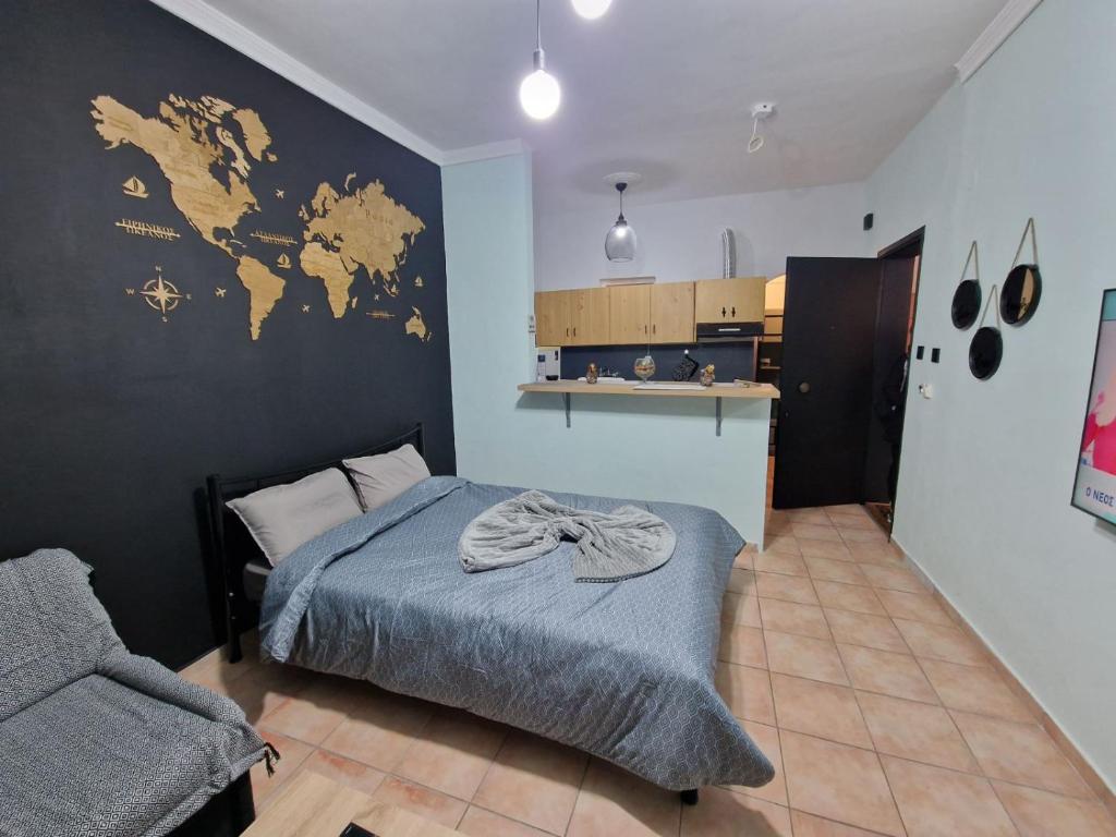 a bedroom with a bed and a map on the wall at Amazing studio Φωλιά in Xanthi - myHomee in Xanthi