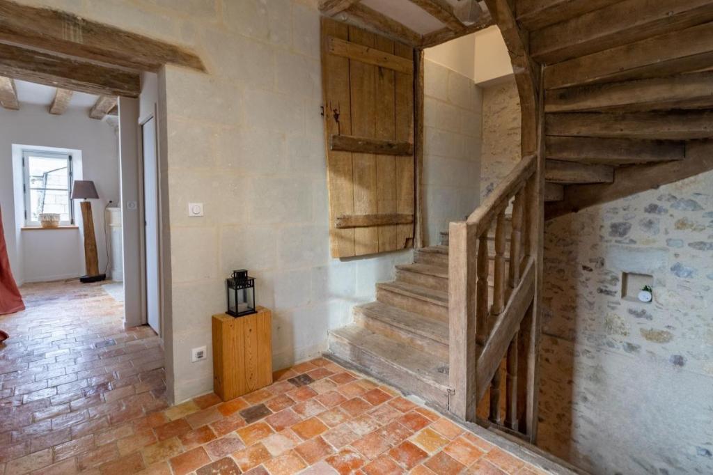 a hallway with wooden stairs in a house at Gîte Apolise in Saint-Rémy-la-Varenne