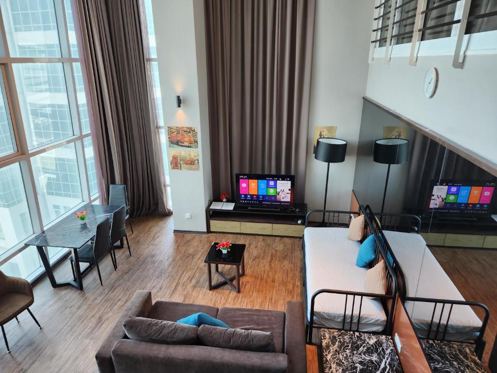 a living room with a couch and a table at Fantastic Seaview Loft 2R2B 9Pax #Maritime in Jelutong