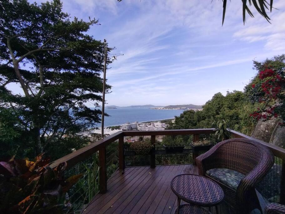 a deck with two chairs and a view of the ocean at Casa Inteira em Jurerê In e vista panorâmica in Florianópolis