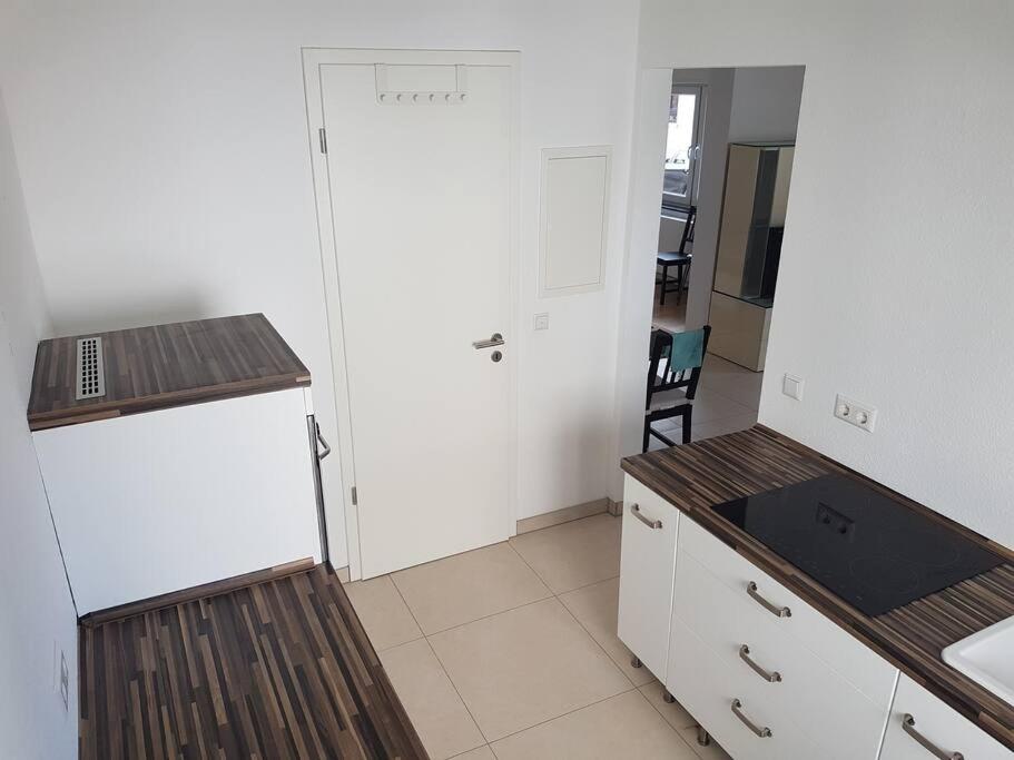 a kitchen with a white refrigerator and a table at Mondorf - klein aber fein zwischen Bonn & Köln in Niederkassel