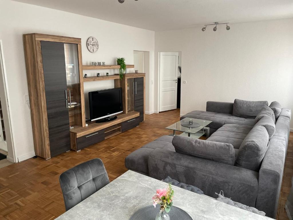 a living room with a couch and a tv at Havel Homes Apartment mit 3 SZ und Netflix in Brandenburg an der Havel