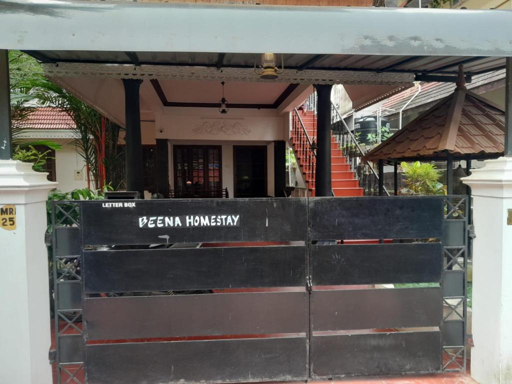 a building with a gate with the entrance to a restaurant at Beena Homestay in Fort Kochi