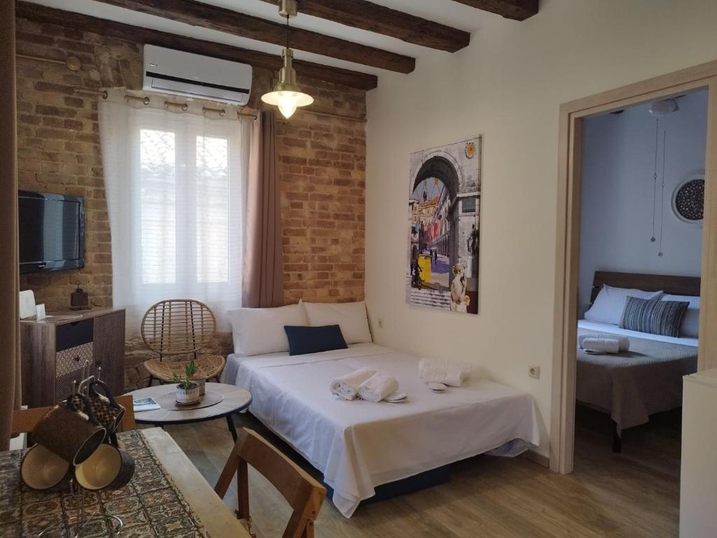 a bedroom with a bed and a living room at Casa Collage in Corfu Town