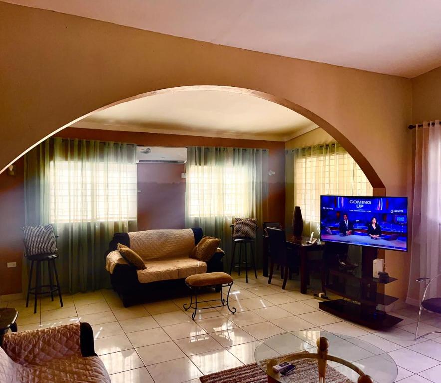 a living room with an archway with a tv in it at Portmore Havens 1Bedroom EntireGuest House in Portmore