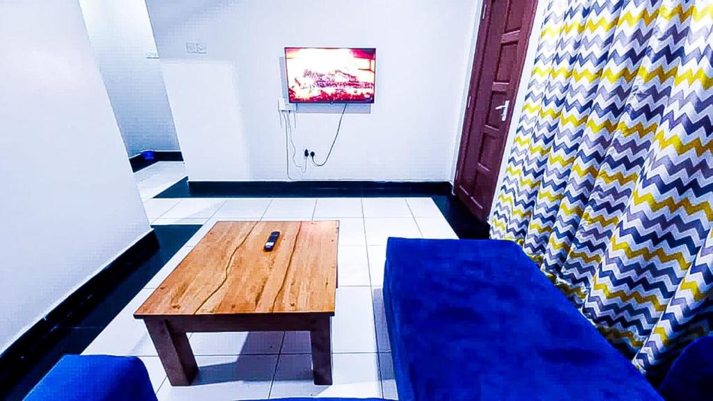 een kamer met een bank, een tafel en een basketbalring bij One Bedroom at Bamburi in Mombasa