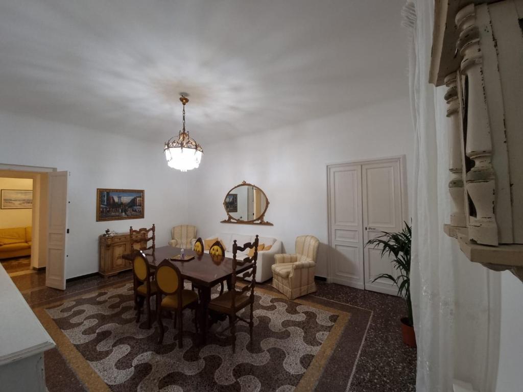 jadalnia ze stołem i krzesłami w pokoju w obiekcie Wow Home - 175 mq - posteggio privato - davanti porto traghetti - fino a 10 posti letto w Genui