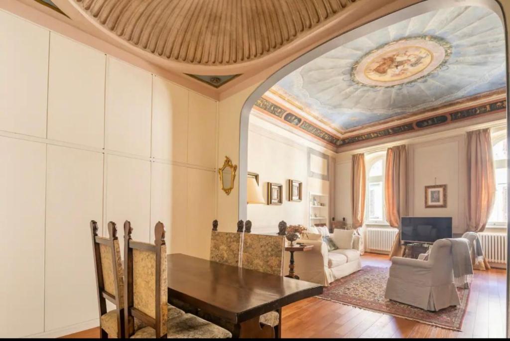 a living room with a table and a ceiling at Lusso e Charme! in Florence