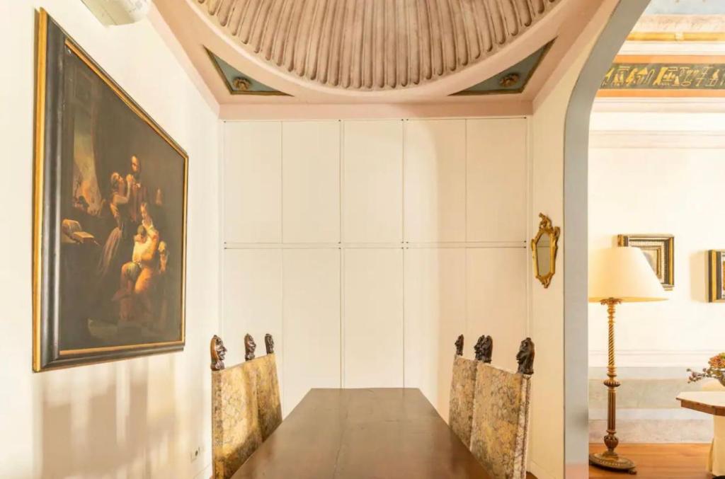 a dining room with a painting on the wall at Lusso e Charme! in Florence
