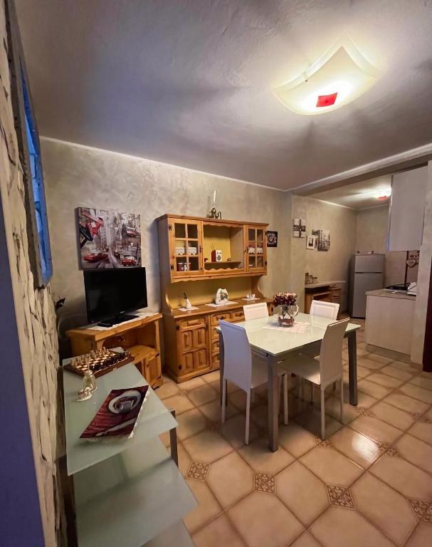 a kitchen and dining room with a table and chairs at Dimora dell'Etna in Randazzo