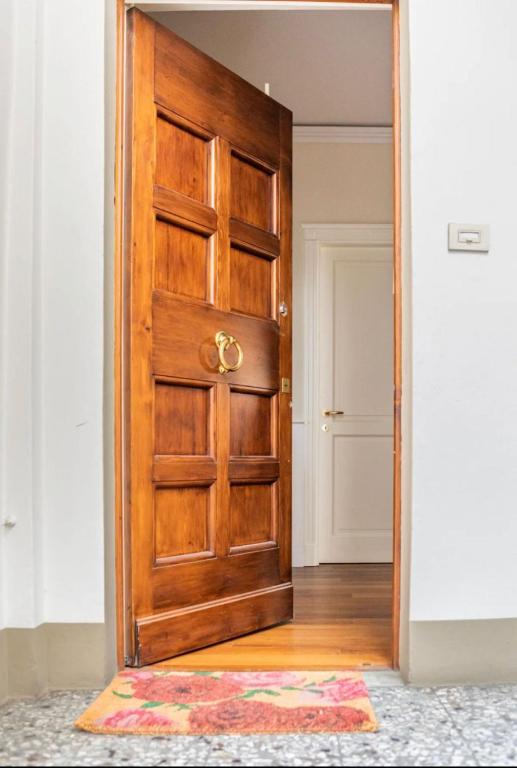 a wooden door in a room with a rug at Lusso e Charme! in Florence