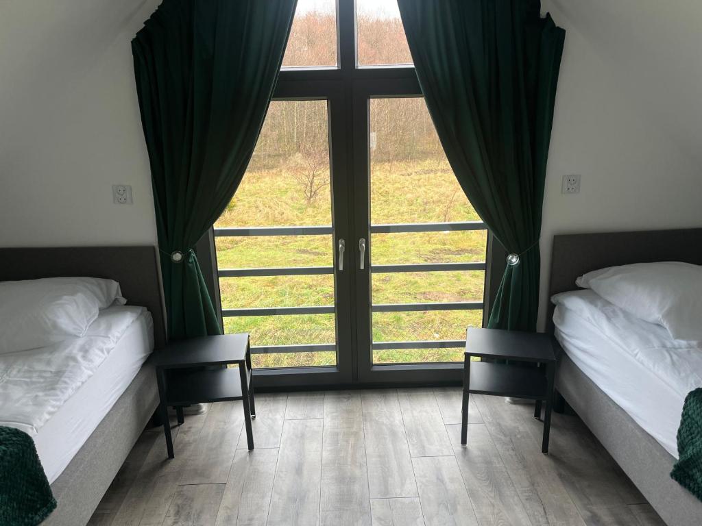 Postel nebo postele na pokoji v ubytování Domki nad morzem " Przy Lesie"