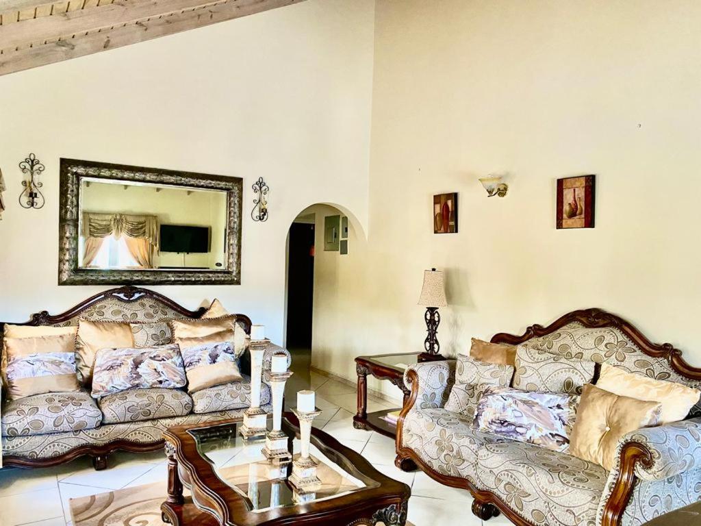 a living room with two couches and a table at Casa Amarilla in Woods