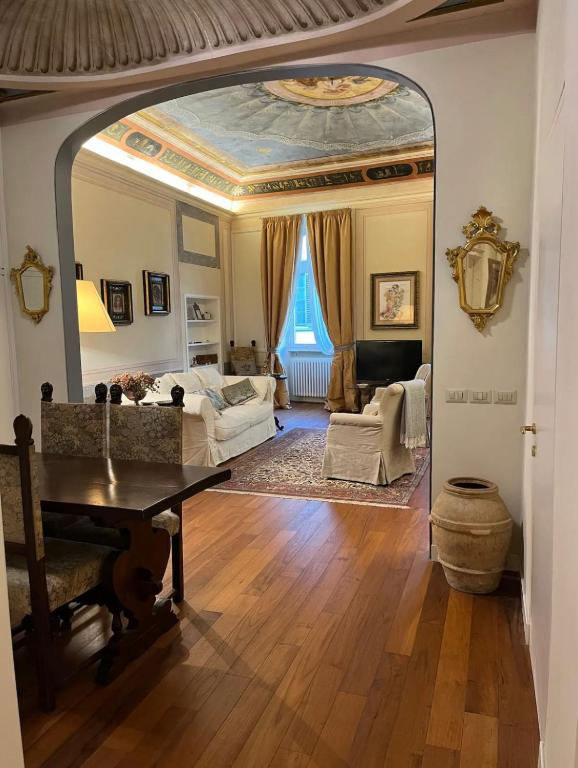 a living room with a table and a large mirror at Lusso e Charme! in Florence