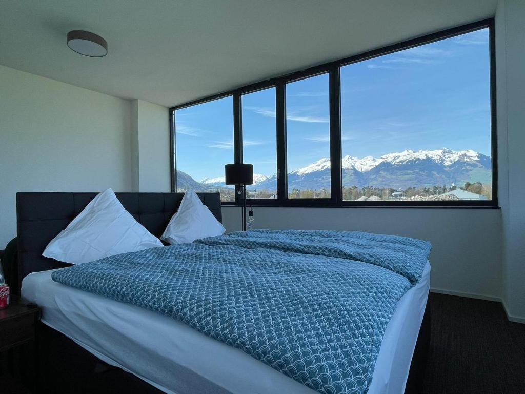 a bedroom with a bed with a view of mountains at Laurin‘s in Schaanwald