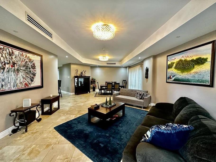 a living room with a couch and a table at Luxurious Retreat in Port-of-Spain