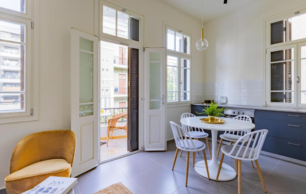 a kitchen and dining room with a table and chairs at Boutique Patio appalments next to Rothschild blvd in Tel Aviv