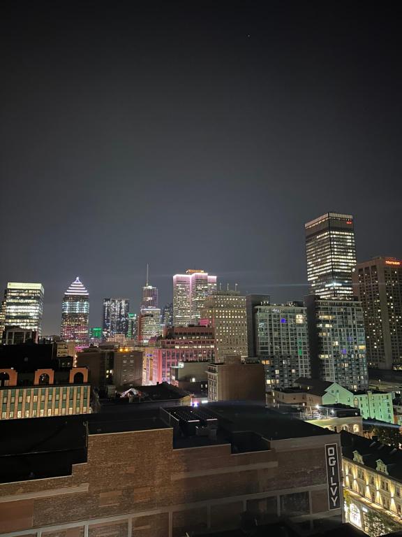 a view of a city skyline at night at Hello,CRESCENT in Montreal