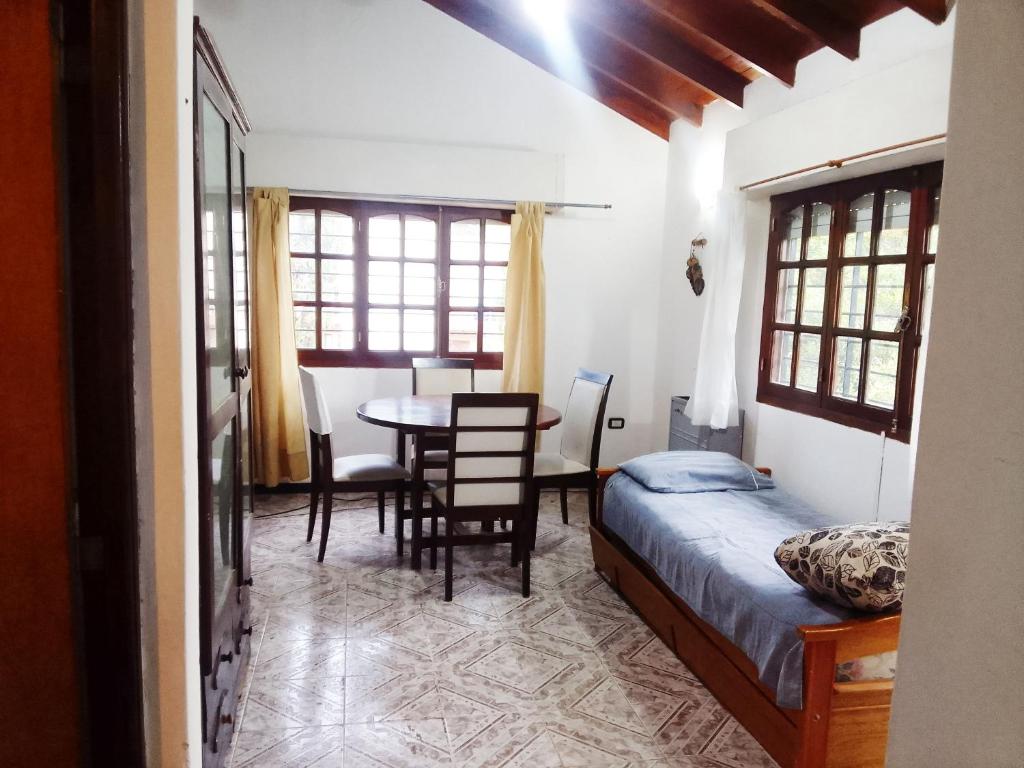 een slaapkamer met een bed en een tafel en stoelen bij Norte, 310 in Villa Gesell