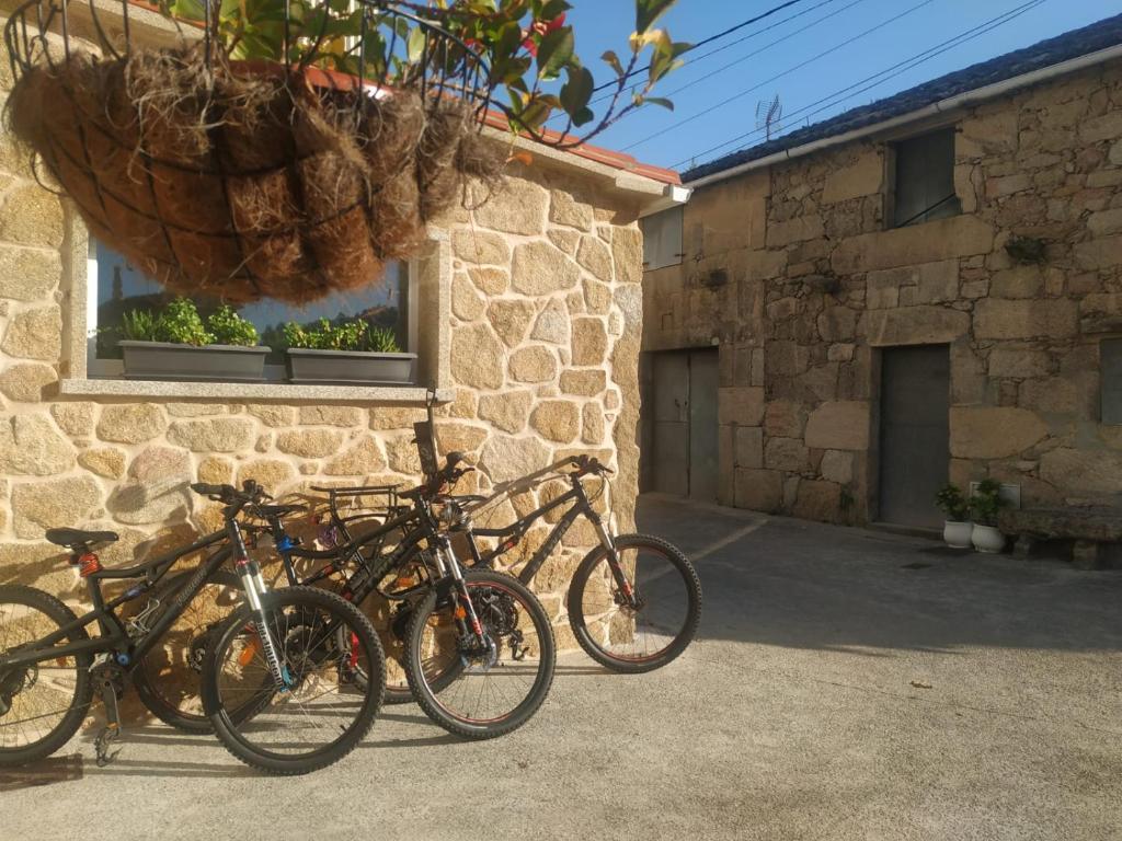 a group of bikes parked outside of a building at O berce casa rural camino Padrón Santiago in Padrón