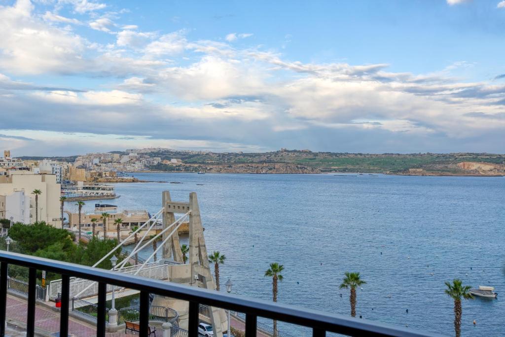 a view of a large body of water with palm trees at SPB26 - Seafront House in Bugibba in St Paul's Bay