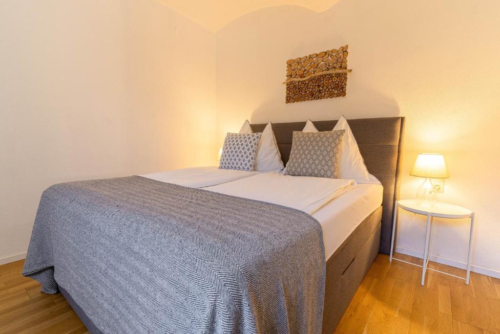 1 dormitorio con 1 cama grande con manta azul en Moderne 2-Zimmer Wohnung, en Gratwein