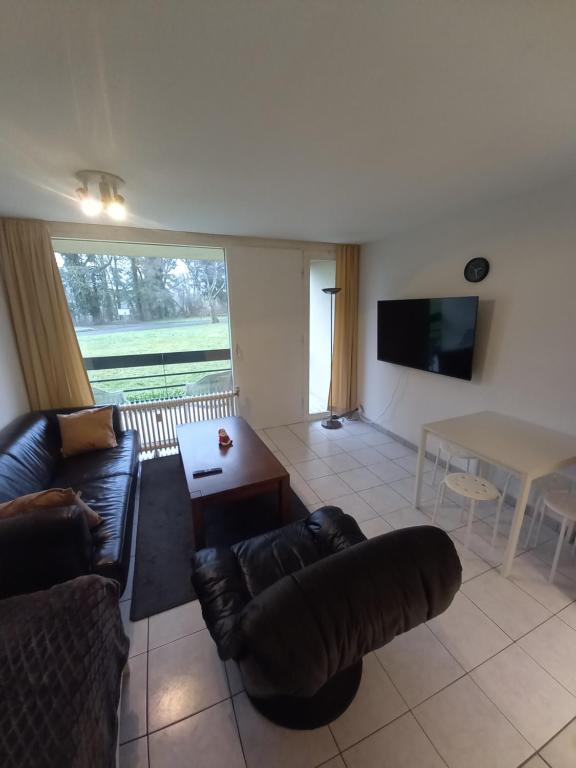 a living room with a couch and a table at Ap5 Nature Ardennes Economy class apartment in La Calamine