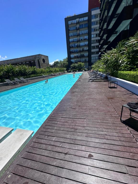 a large swimming pool with people in the water at Quartier Dorrego in Buenos Aires