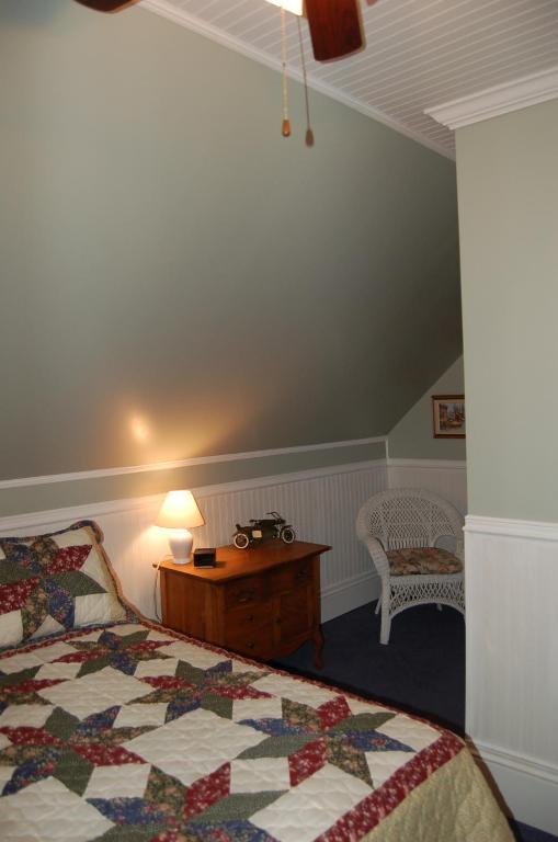 a bedroom with a bed and a table with a lamp at The Yellow Sidecar B&B in Cap Le Moine