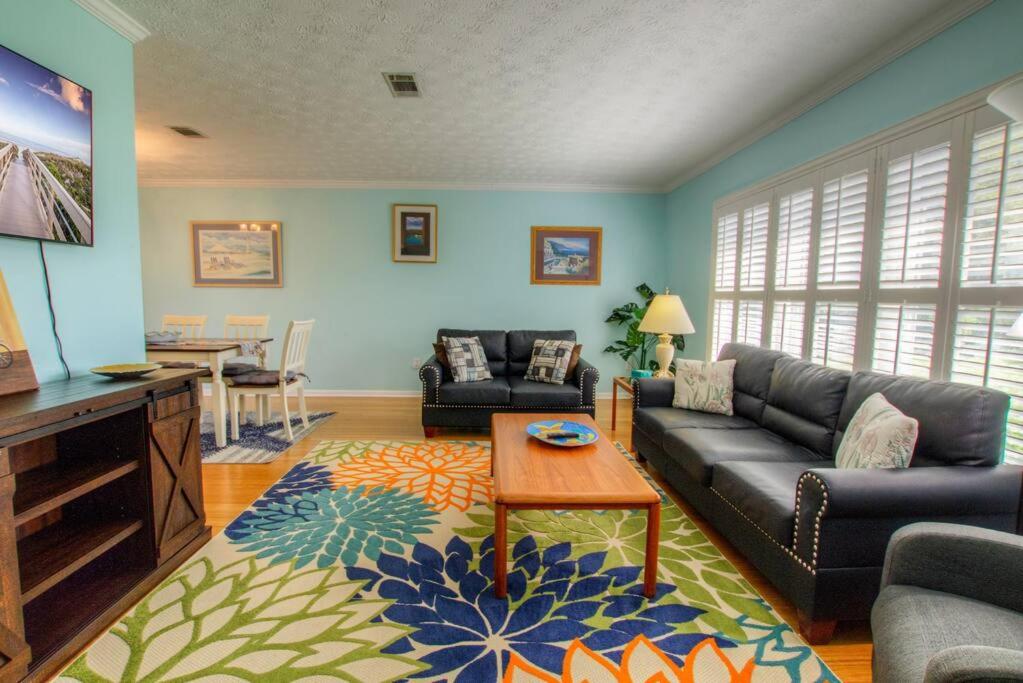 uma sala de estar com um sofá e uma mesa em Seashell Hideout with Pool em Ponte Vedra Beach
